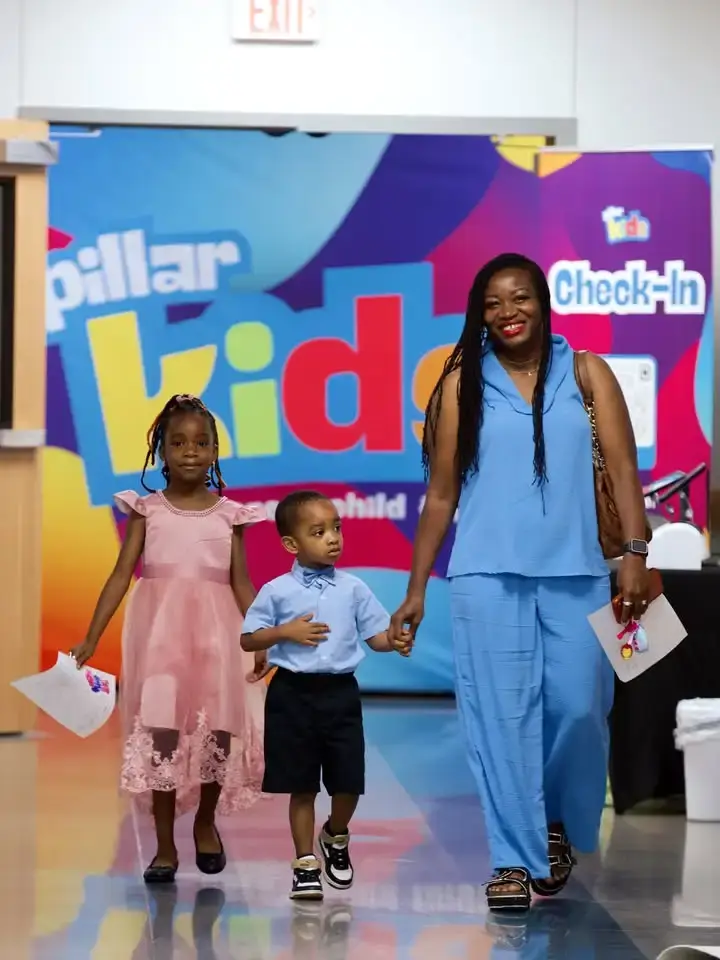 A family at the Pillar Kids check-in area