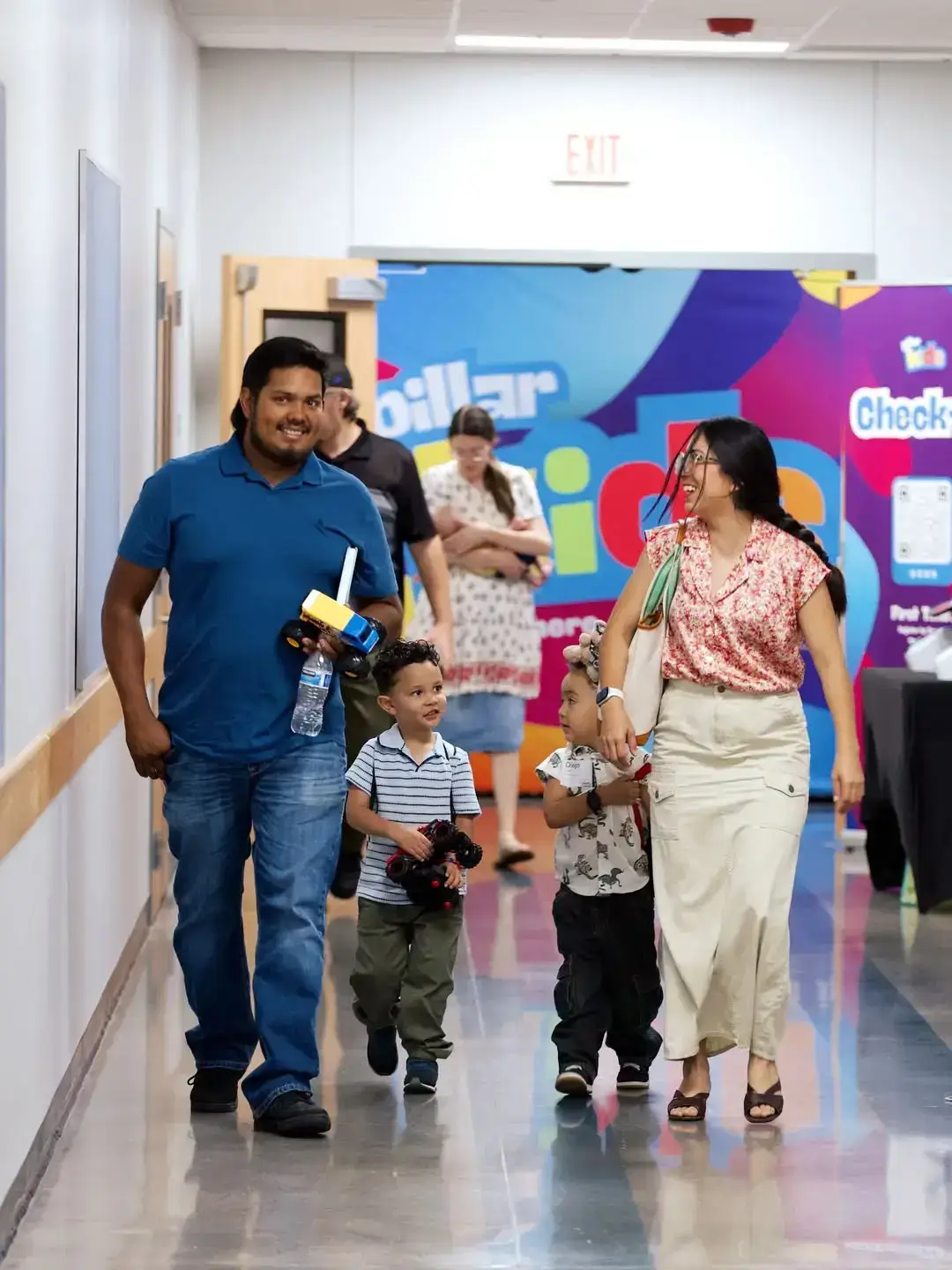 A family walking toward Pillar Kids check-in on Sunday morning