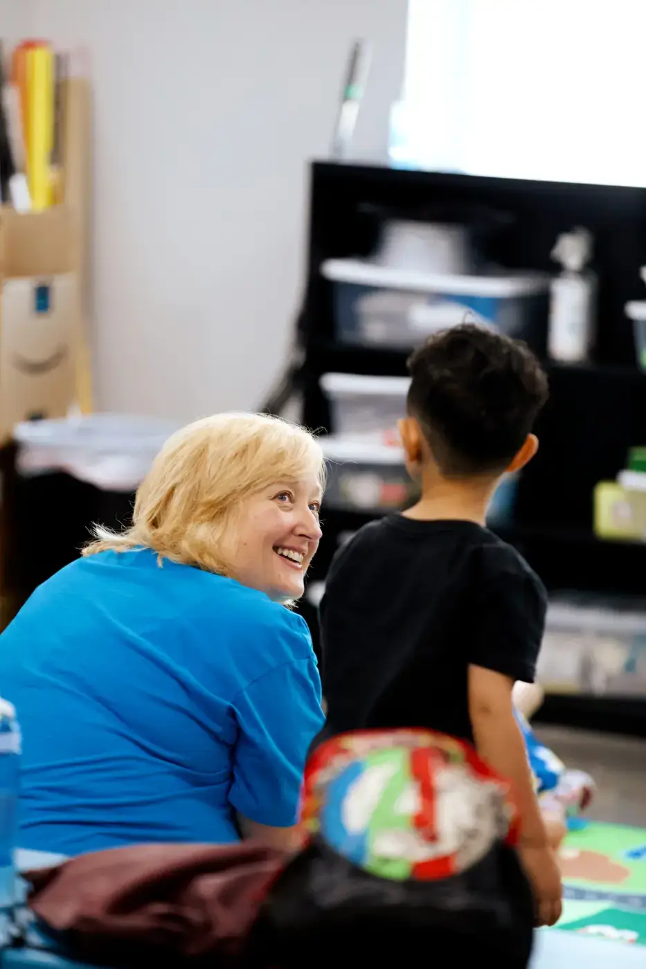 A Pillar Kids volunteer connecting with a child