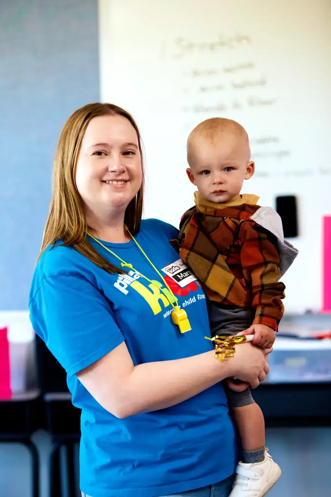 A Pillar Kids volunteer caring for a toddler